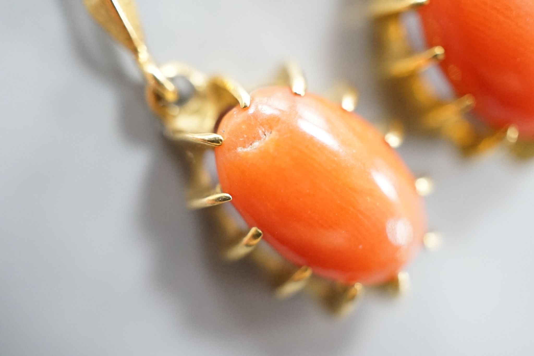 A pair of 18k and oval coral bead set drop earrings, 39mm, gross weight 6.8 grams.